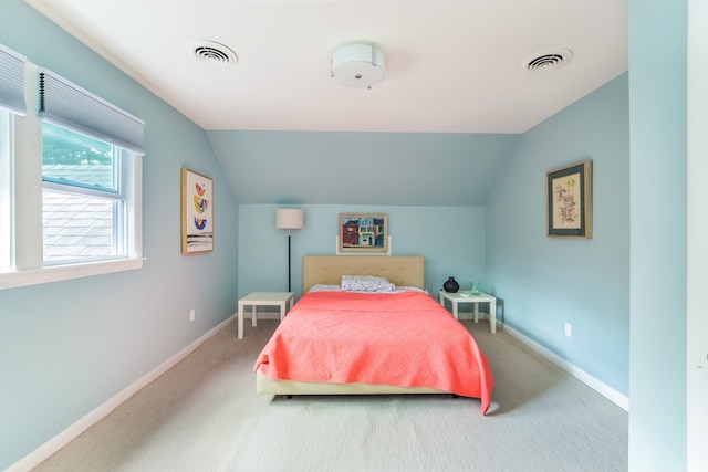 carpeted bedroom with vaulted ceiling