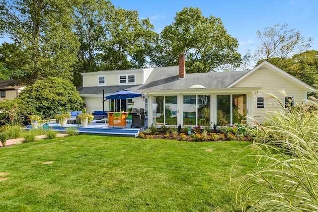 back of house featuring a patio and a yard