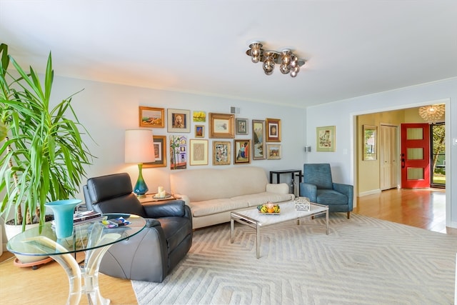 living room with light wood-type flooring and crown molding