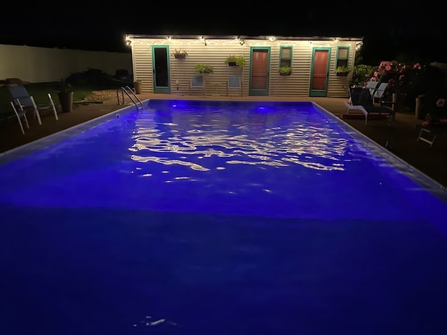 pool at twilight with a patio