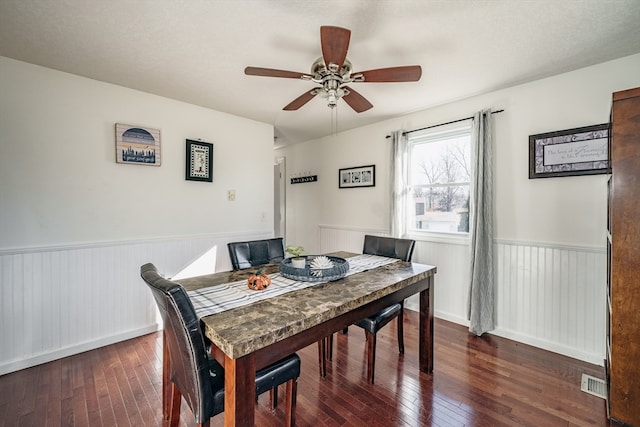 dining space with ceiling fan and dark hardwood / wood-style floors