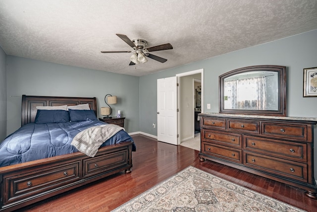 bedroom featuring a textured ceiling, dark hardwood / wood-style flooring, and ceiling fan