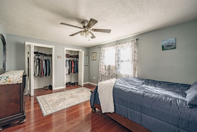 bedroom featuring ceiling fan, dark hardwood / wood-style floors, and a textured ceiling