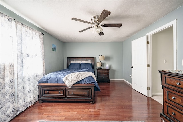 bedroom featuring ceiling fan, a textured ceiling, and dark hardwood / wood-style flooring