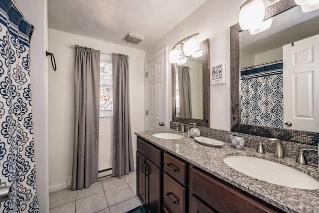 bathroom featuring vanity, a textured ceiling, tile patterned flooring, and a baseboard heating unit