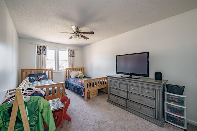 bedroom with a textured ceiling, light carpet, and ceiling fan