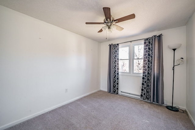 spare room with ceiling fan, a baseboard radiator, and carpet flooring