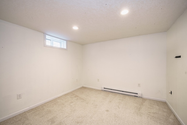 basement with a baseboard radiator and light colored carpet