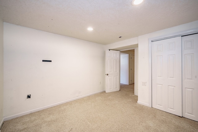 unfurnished bedroom with a closet and light colored carpet