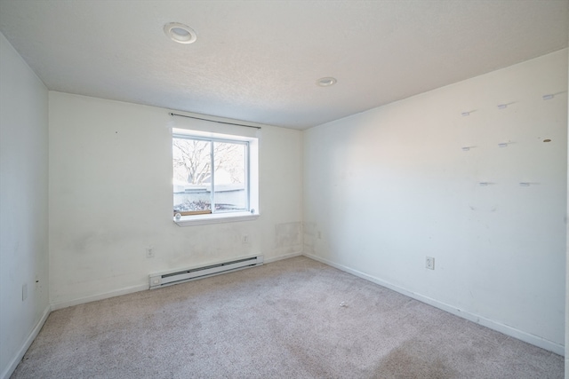 empty room with light carpet and a baseboard heating unit