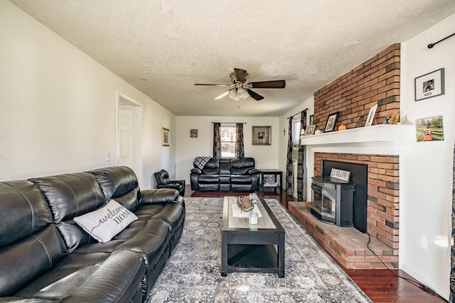 living room with ceiling fan, dark hardwood / wood-style floors, and a textured ceiling