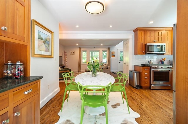 79 Henderson St, Needham, MA 02492 - kitchen with stainless steel appliances, wood finished floors, tasteful backsplash, brown cabinets, and recessed lighting