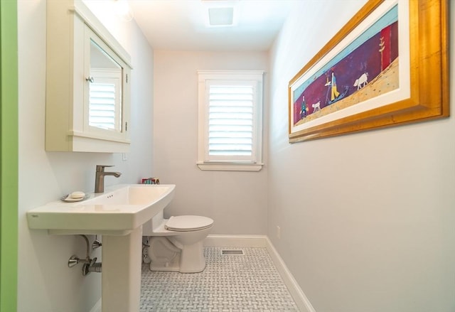 79 Henderson St, Needham, MA 02492 - half bathroom featuring toilet and baseboards