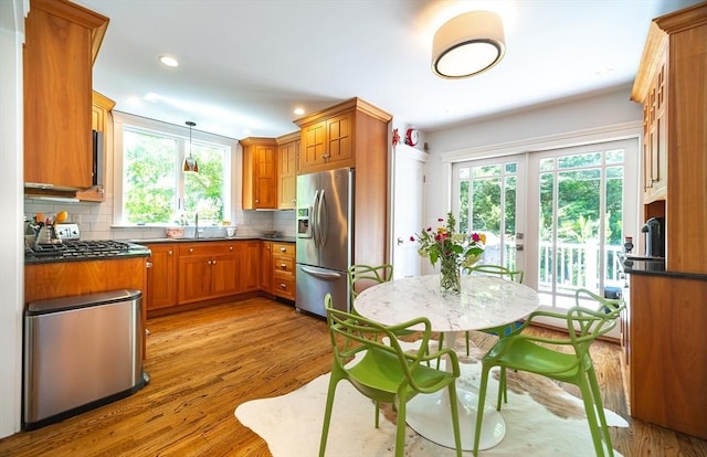 79 Henderson St, Needham, MA 02492 - kitchen with stainless steel fridge with ice dispenser, healthy amount of natural light, dark countertops, backsplash, and recessed lighting