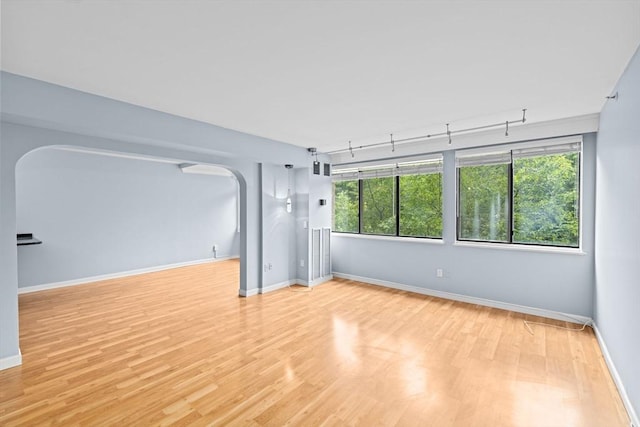 250 Hammond Pond Pkwy Unit 409S, Newton, MA 02467 - spare room with arched walkways and wood finished floors