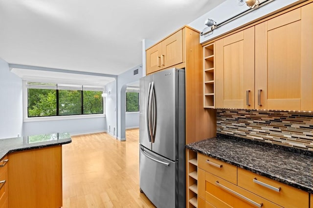 250 Hammond Pond Pkwy Unit 409S, Newton, MA 02467 - kitchen with freestanding refrigerator, decorative backsplash, light wood-style flooring, and dark stone counters