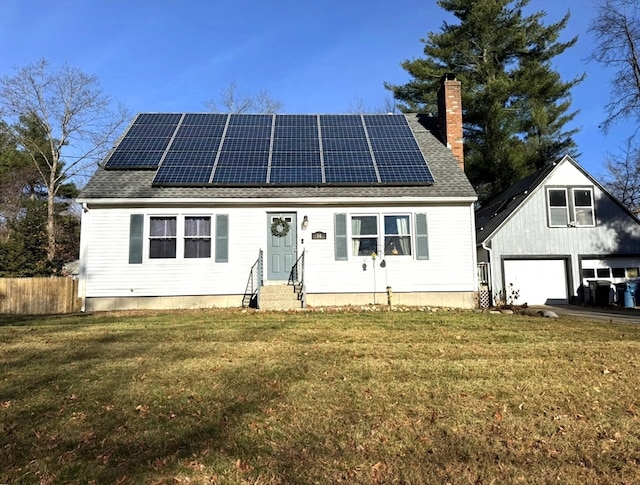 view of front facade featuring a front yard, solar panels, and a garage