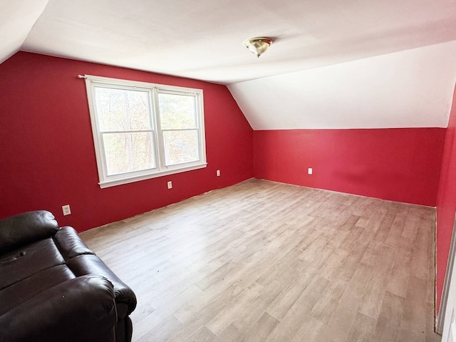 bonus room with light hardwood / wood-style flooring and lofted ceiling