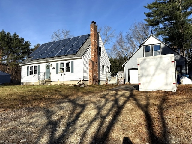 rear view of house featuring solar panels