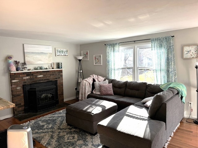 living room with wood-type flooring and a wood stove