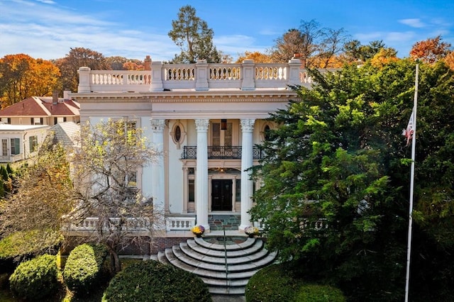 neoclassical / greek revival house featuring a balcony