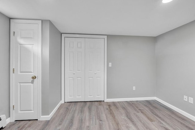 10 Briarcliff Ln, Paxton, MA 01612 - unfurnished bedroom featuring a baseboard heating unit, wood finished floors, and baseboards