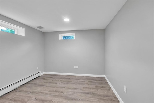 10 Briarcliff Ln, Paxton, MA 01612 - below grade area featuring a baseboard radiator, healthy amount of natural light, recessed lighting, and wood finished floors
