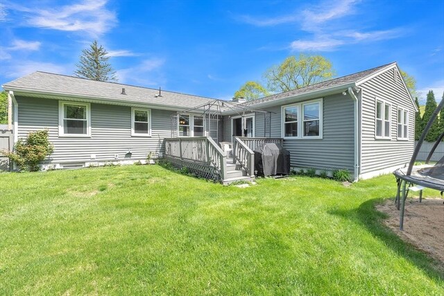 10 Briarcliff Ln, Paxton, MA 01612 - back of property featuring a trampoline, a wooden deck, and a yard