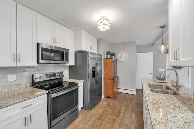 10 Briarcliff Ln, Paxton, MA 01612 - kitchen with appliances with stainless steel finishes, a baseboard heating unit, a sink, backsplash, and white cabinets