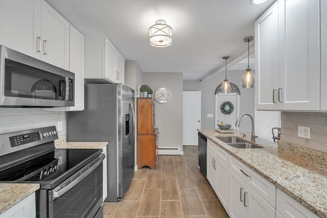 10 Briarcliff Ln, Paxton, MA 01612 - kitchen featuring stainless steel appliances, a sink, a baseboard heating unit, tasteful backsplash, and white cabinetry