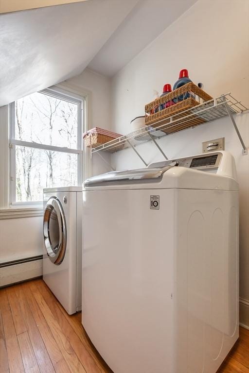 laundry room with washer and clothes dryer, baseboard heating, laundry area, and light wood finished floors