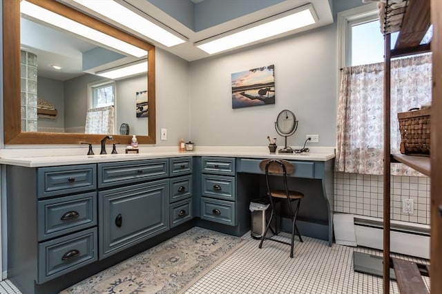 bathroom with tile patterned floors, vanity, and baseboard heating
