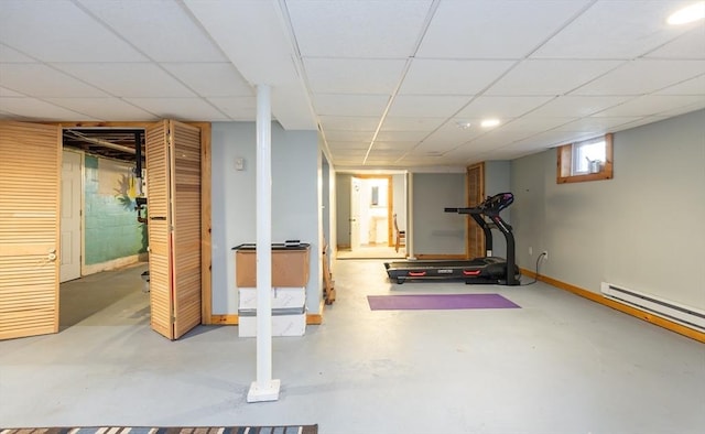 exercise area with baseboards and a paneled ceiling