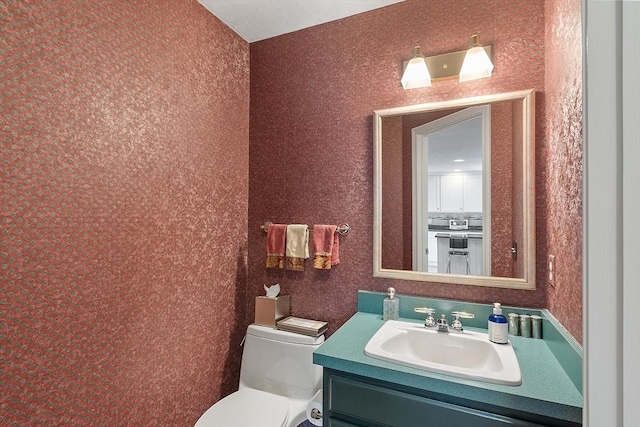 bathroom with vanity and toilet