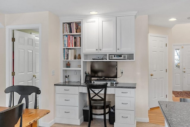 office area featuring built in desk and light wood-type flooring