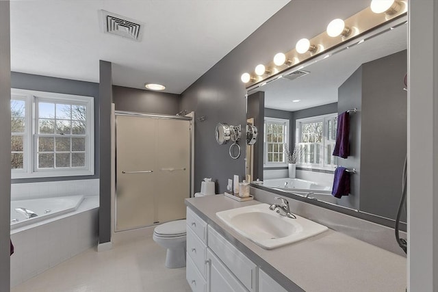 full bathroom featuring vanity, toilet, and separate shower and tub