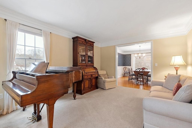 miscellaneous room with crown molding, light carpet, and an inviting chandelier