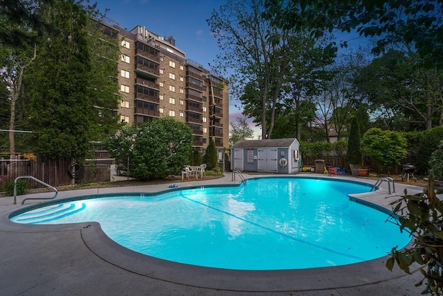 view of pool featuring a shed