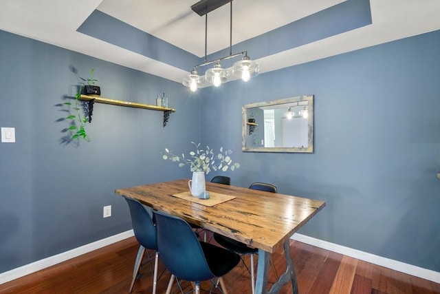 dining area with dark hardwood / wood-style flooring