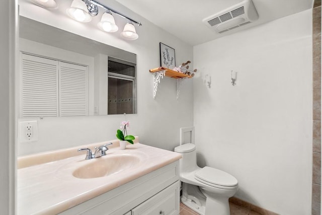 bathroom featuring vanity, tile patterned floors, a shower with door, and toilet