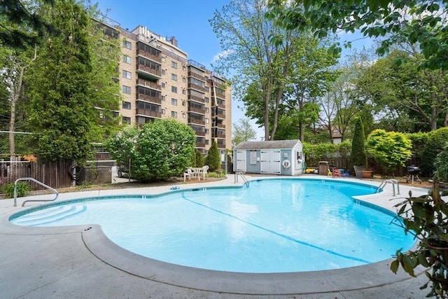 view of pool featuring a storage unit