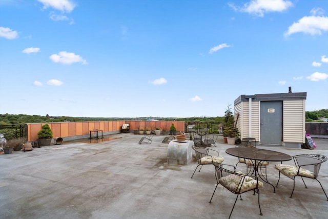 view of patio with a storage unit