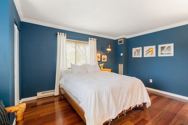 bedroom with ornamental molding, dark hardwood / wood-style floors, and a baseboard heating unit