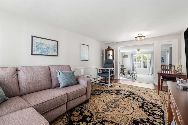 living area featuring a ceiling fan and wood finished floors