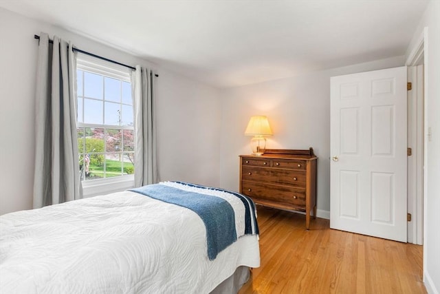 bedroom with baseboards and light wood-style flooring