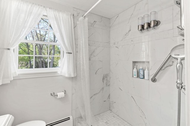full bath with a stall shower, toilet, a wealth of natural light, and a baseboard heating unit