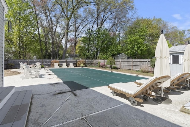 view of swimming pool featuring a patio, a fenced in pool, and a fenced backyard