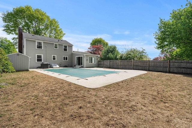 view of pool featuring a lawn, a patio area, and a fenced backyard