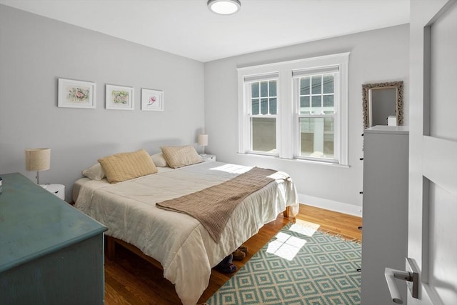 bedroom featuring baseboards and wood finished floors