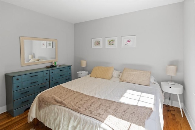 bedroom featuring dark wood-type flooring and baseboards